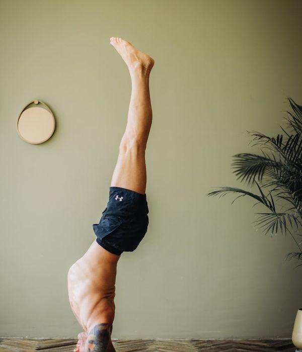 Male athlete in a powerful yoga warrior pose, demonstrating strength and balance.